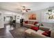 Cozy living room features wood floors, a ceiling fan, and comfortable seating, perfect for relaxation and gatherings at 1210 W Missouri Ave, Phoenix, AZ 85013
