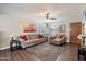 Comfortable living room with a ceiling fan, wood-look flooring, and stylish decor creating a welcoming atmosphere at 1210 W Missouri Ave, Phoenix, AZ 85013