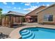 Enjoy this home's backyard with a beautiful pool, gazebo, and patio set against clear blue skies at 125 N 107Th Dr, Avondale, AZ 85323