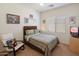 Guest bedroom with window and decorated with modern chair and comfortable bed at 125 N 107Th Dr, Avondale, AZ 85323