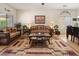 Cozy living room boasting stylish furnishings, a decorative rug, and bright windows for a warm, inviting atmosphere at 125 N 107Th Dr, Avondale, AZ 85323