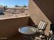 Outdoor balcony seating area with a small table and seating for relaxing outdoors at 1406 W Emerald Ave # 124, Mesa, AZ 85202