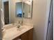Bathroom featuring a double sink vanity, medicine cabinets, and a neutral color scheme at 1406 W Emerald Ave # 124, Mesa, AZ 85202