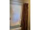 Bathroom featuring a shower/tub combo with white tile and a brown shower curtain at 1406 W Emerald Ave # 124, Mesa, AZ 85202