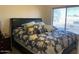 Bedroom with a large bed, nightstand and big bright windows at 1406 W Emerald Ave # 124, Mesa, AZ 85202