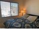 Bedroom with a big window and a bed with blue, patterned bedding at 1406 W Emerald Ave # 124, Mesa, AZ 85202