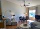 Bright living space with laminate floors, dining area and a large window with natural light at 1406 W Emerald Ave # 124, Mesa, AZ 85202