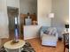 Cozy living space with a comfortable chair, laminate flooring and kitchen access at 1406 W Emerald Ave # 124, Mesa, AZ 85202