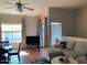 Bright living room with a ceiling fan, large window and TV for relaxing and entertaining at 1406 W Emerald Ave # 124, Mesa, AZ 85202