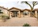 Back exterior with covered patio, seating and views of desert landscaping offering an ideal outdoor living space at 14000 N 94Th St # 1031, Scottsdale, AZ 85260