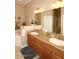 Bathroom vanity with double sinks, wooden cabinets, granite countertop, and decorative lighting at 14000 N 94Th St # 1031, Scottsdale, AZ 85260