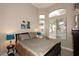 Bright bedroom featuring a large window, comfortable queen bed, and neutral paint at 14000 N 94Th St # 1031, Scottsdale, AZ 85260