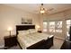 Inviting bedroom with a comfortable bed, ceiling fan, and a view of the desert landscape at 14000 N 94Th St # 1031, Scottsdale, AZ 85260