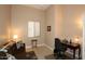 Office area with desk near sofa and window in a naturally lit bedroom at 14000 N 94Th St # 1031, Scottsdale, AZ 85260