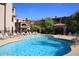 Apartment community pool with blue water and lounge chairs at 14000 N 94Th St # 1031, Scottsdale, AZ 85260