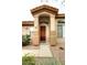 Close up of home's front entrance with wood door and desert landscaping adds warmth and character to the property at 14000 N 94Th St # 1031, Scottsdale, AZ 85260