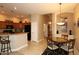 Kitchen area with granite countertops, wooden cabinets, black appliances, and dining table at 14000 N 94Th St # 1031, Scottsdale, AZ 85260