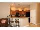 Spacious kitchen with granite countertops, wooden cabinets, black appliances, and breakfast bar seating at 14000 N 94Th St # 1031, Scottsdale, AZ 85260