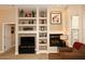 Living room with fireplace, shelving, and neutral color palette offers a stylish and comfortable gathering space at 14000 N 94Th St # 1031, Scottsdale, AZ 85260