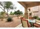 Covered patio area with gravel, landscaping, table and seating at 14000 N 94Th St # 1031, Scottsdale, AZ 85260