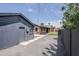 Exterior view of a home's backyard featuring a detached structure, gravel and concrete at 1551 W Vernon Ave, Phoenix, AZ 85007