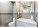 Stylish powder room with decorative mirror, granite countertop, and attractive wood paneling at 1551 W Vernon Ave, Phoenix, AZ 85007