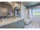 Bright bathroom featuring double vanity, soaking tub, subway tile, and decorative mirrors at 1551 W Vernon Ave, Phoenix, AZ 85007