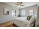 Bedroom features hardwood floors, ceiling fan and natural light from the exterior windows and door at 1551 W Vernon Ave, Phoenix, AZ 85007