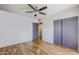 Spacious bedroom showcasing hardwood floors, ceiling fan, large closet and neutral colors at 1551 W Vernon Ave, Phoenix, AZ 85007