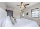 Inviting bedroom offers plush bedding, natural light, and a ceiling fan for comfort at 1551 W Vernon Ave, Phoenix, AZ 85007