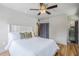 Comfortable bedroom features a ceiling fan, ensuite bathroom, and natural light from windows at 1551 W Vernon Ave, Phoenix, AZ 85007