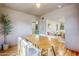 Dining area with hardwood floors, a wooden table, and an open view to the living room at 1551 W Vernon Ave, Phoenix, AZ 85007