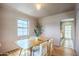 Bright dining room with hardwood floors, a wooden table, and seating for four at 1551 W Vernon Ave, Phoenix, AZ 85007