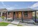 Close-up of a brick home's entrance with a cozy porch and a welcoming wooden door at 1551 W Vernon Ave, Phoenix, AZ 85007