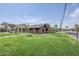 Well-maintained brick home with a tidy lawn, complemented by a modern walkway and mature trees at 1551 W Vernon Ave, Phoenix, AZ 85007