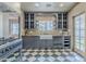 Inviting kitchen features shaker cabinets, farmhouse sink, and black and white checkered flooring at 1551 W Vernon Ave, Phoenix, AZ 85007