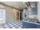 Modern kitchen boasts a black and white tile floor, stainless steel appliances, and ample storage at 1551 W Vernon Ave, Phoenix, AZ 85007
