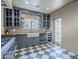 Well-designed kitchen showcasing shaker cabinets, farmhouse sink, and black and white checkered flooring at 1551 W Vernon Ave, Phoenix, AZ 85007