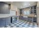 Spacious kitchen with gray cabinetry, farmhouse sink, checkered flooring and open layout, perfect for cooking at 1551 W Vernon Ave, Phoenix, AZ 85007