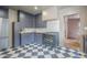 Stylish kitchen featuring custom cabinetry, a professional-grade range, and unique checkered flooring at 1551 W Vernon Ave, Phoenix, AZ 85007