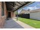 Covered patio with ceiling fans and a view of the backyard with grass, fence, and detached structure at 1551 W Vernon Ave, Phoenix, AZ 85007