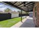 Covered patio featuring concrete flooring, ceiling fans and a view of the fenced backyard with grass at 1551 W Vernon Ave, Phoenix, AZ 85007