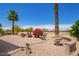 Beautiful backyard with desert landscaping, mature palm trees, and golf course views at 16280 W Desert Winds Dr, Surprise, AZ 85374