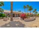 Expansive backyard with desert landscaping, bench seating, and covered patio at 16280 W Desert Winds Dr, Surprise, AZ 85374
