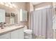 Bright bath featuring a vanity with granite counters and tiled floors at 16280 W Desert Winds Dr, Surprise, AZ 85374