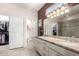 Bathroom featuring double sinks with large mirror and neutral color scheme at 16280 W Desert Winds Dr, Surprise, AZ 85374