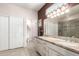 Bathroom featuring double sinks with large mirror and neutral color scheme at 16280 W Desert Winds Dr, Surprise, AZ 85374