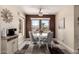 Cozy dining room with brown accent wall and plenty of natural light at 16280 W Desert Winds Dr, Surprise, AZ 85374