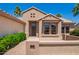 Inviting front entrance with tile walkway, desert landscaping and stylish accent windows at 16280 W Desert Winds Dr, Surprise, AZ 85374