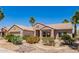 Charming single story home with desert landscaping, lush palms, and a two-car garage at 16280 W Desert Winds Dr, Surprise, AZ 85374